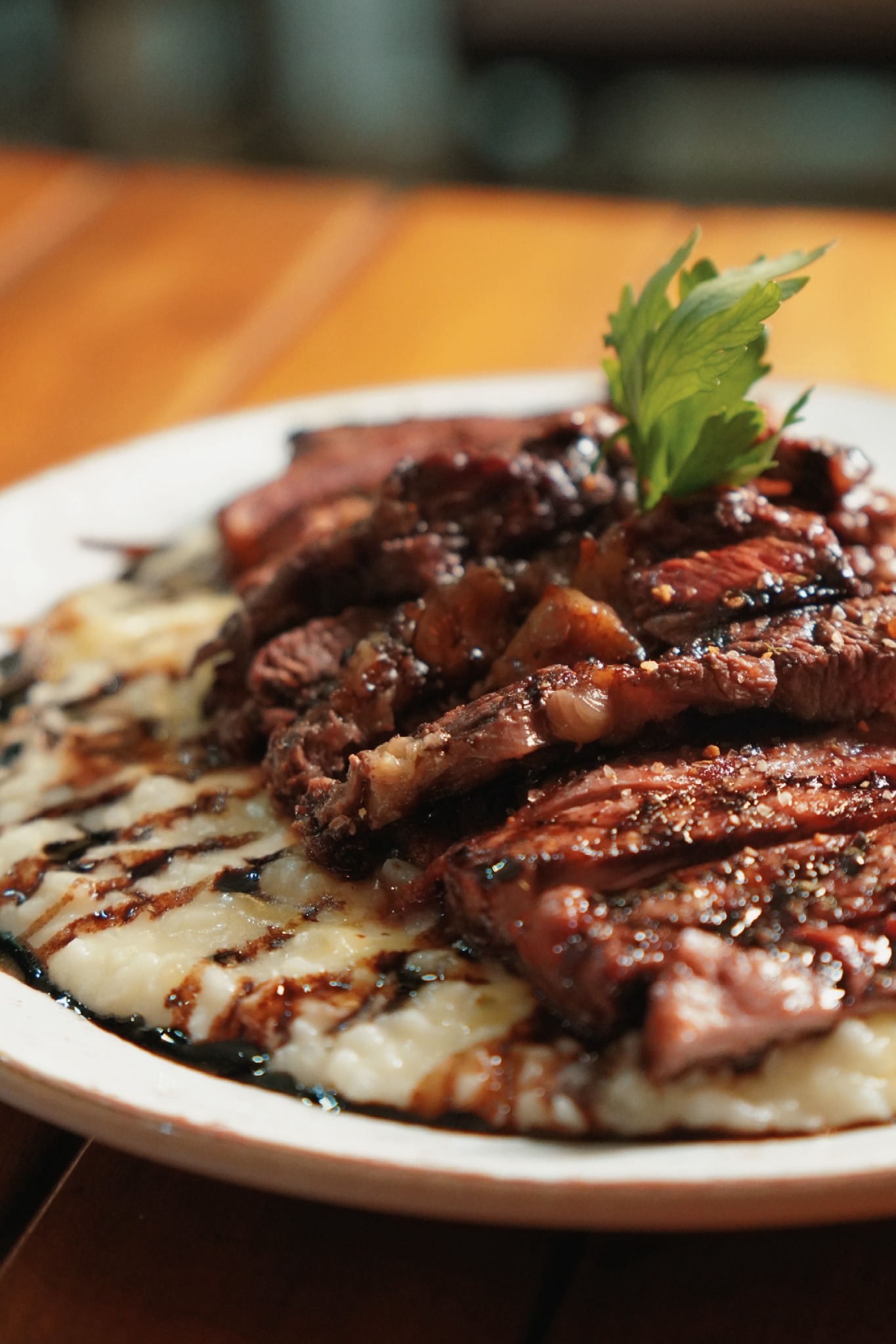 Carne grelhada fatiada sobre risoto cremoso